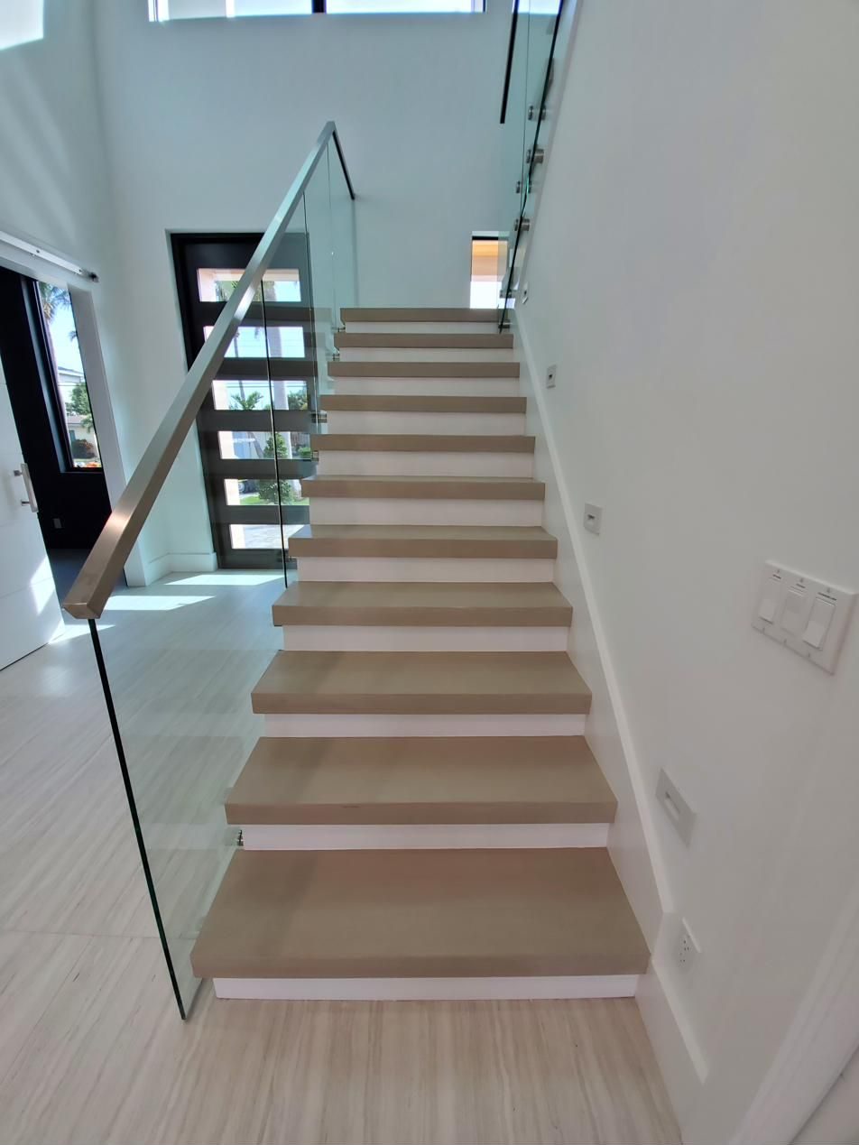 Light wood staircase with glass railing
