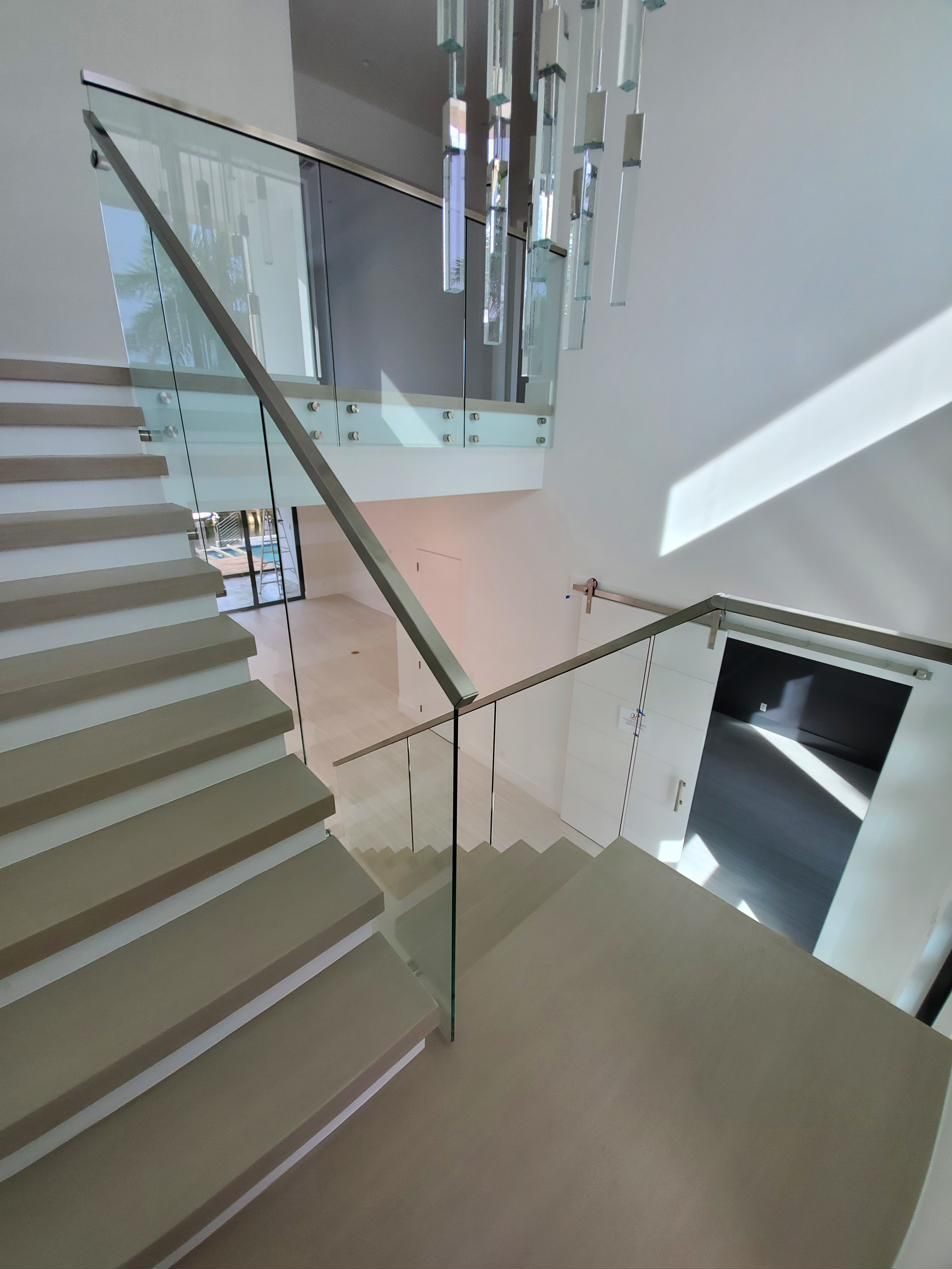 Staircase with glass railing, landing view