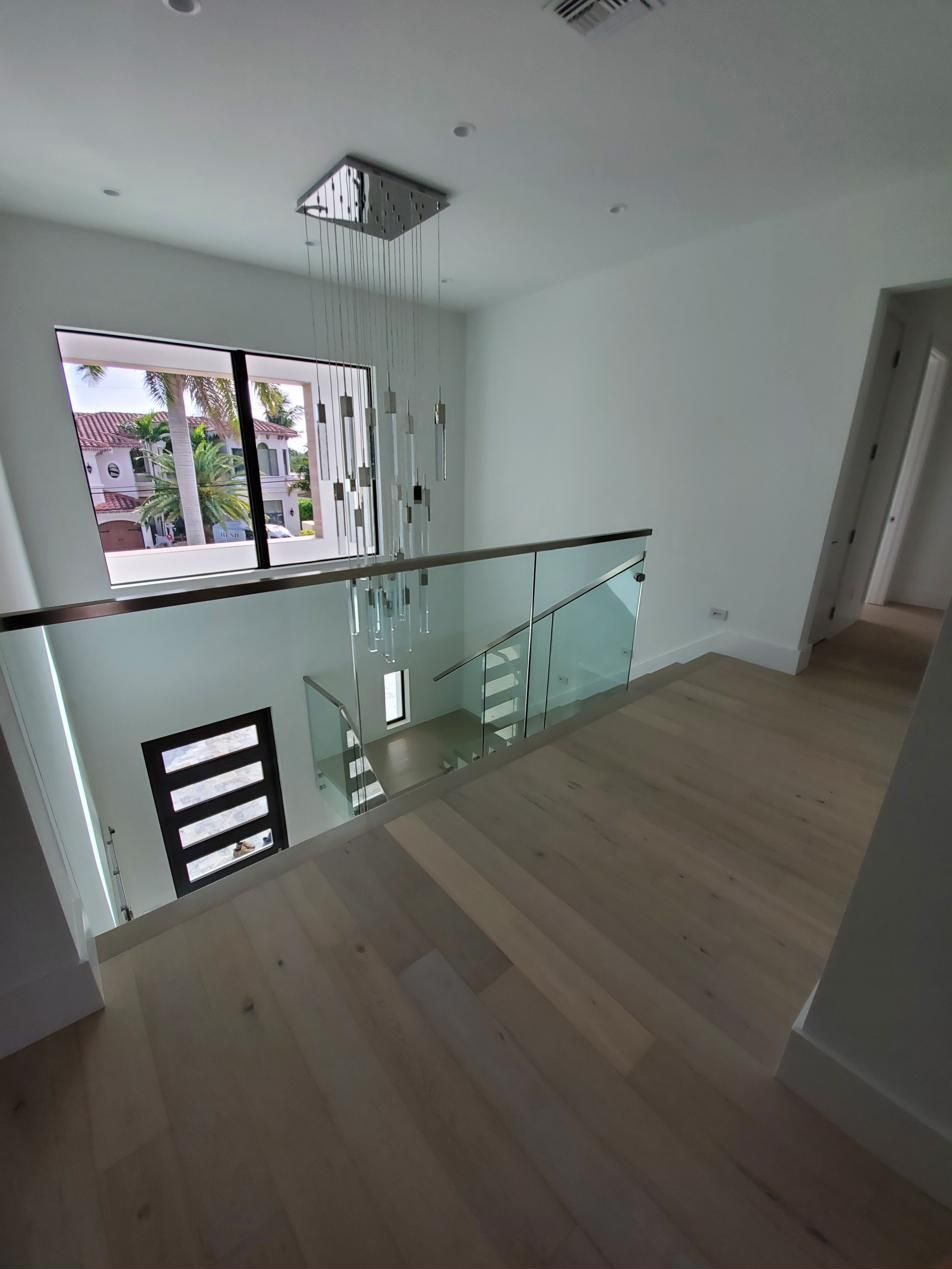Glass-railed landing in a bright foyer