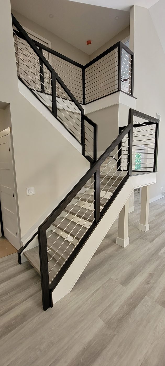 Switchback staircase with stainless rod railing