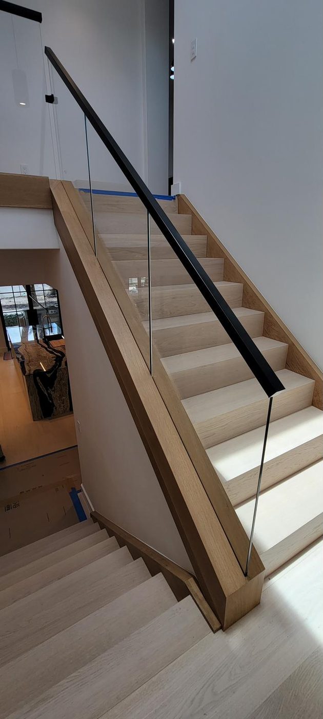 Switchback oak staircase with frameless glass