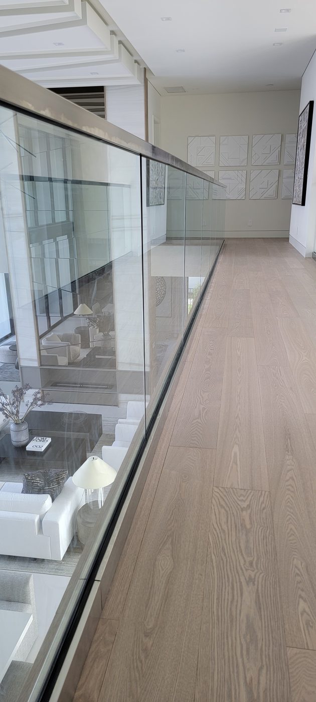 Switchback staircase with frameless glass and wood handrail