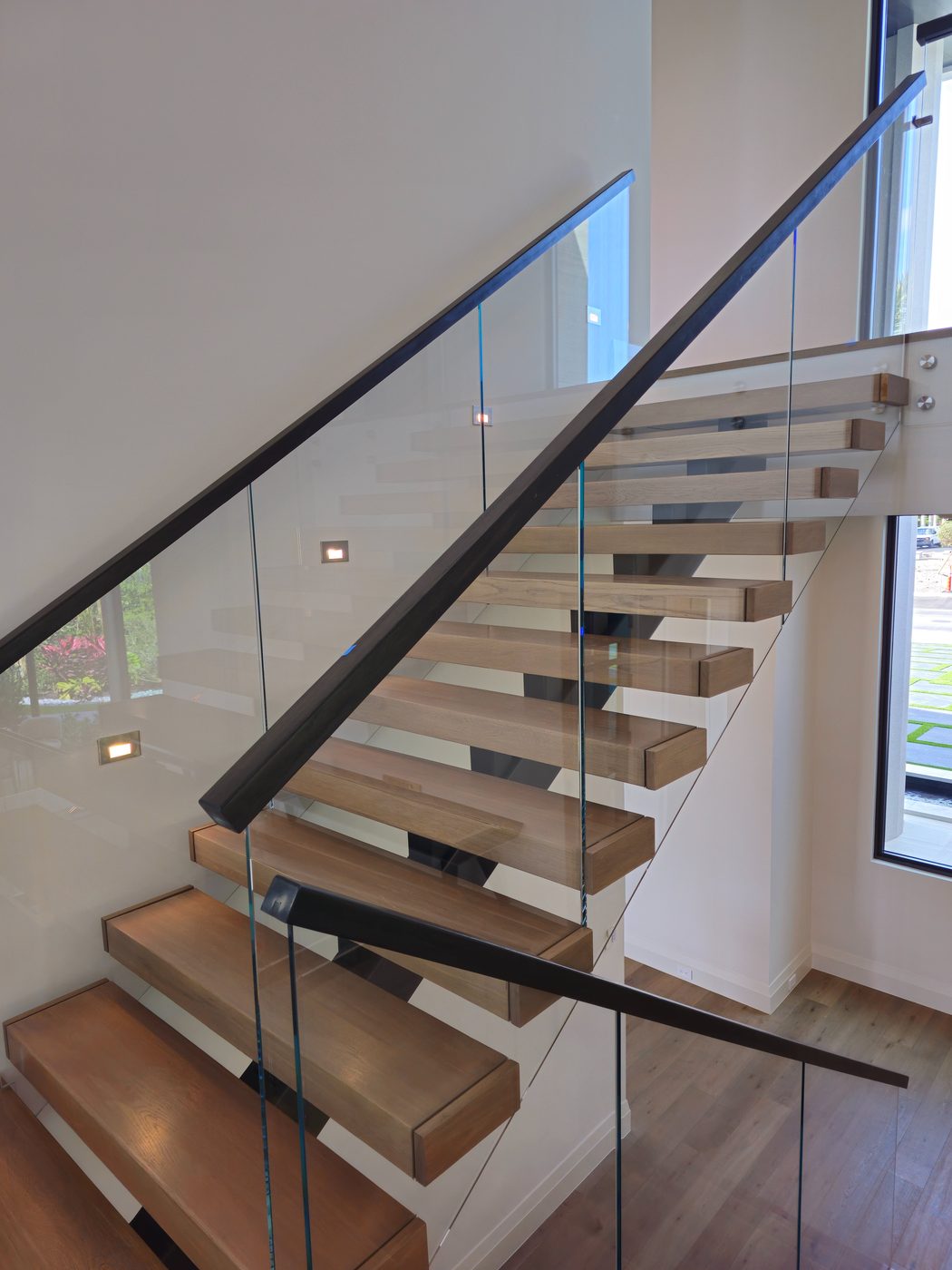 Floating wood staircase with glass railing