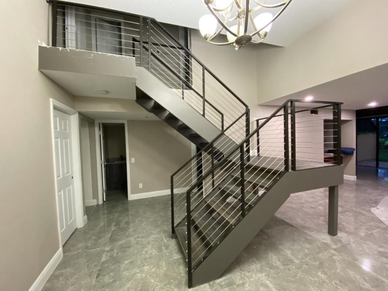 Steel switchback staircase with cable railing
